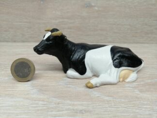 Schleich –13211 Kuh schwarz/weiß, liegend